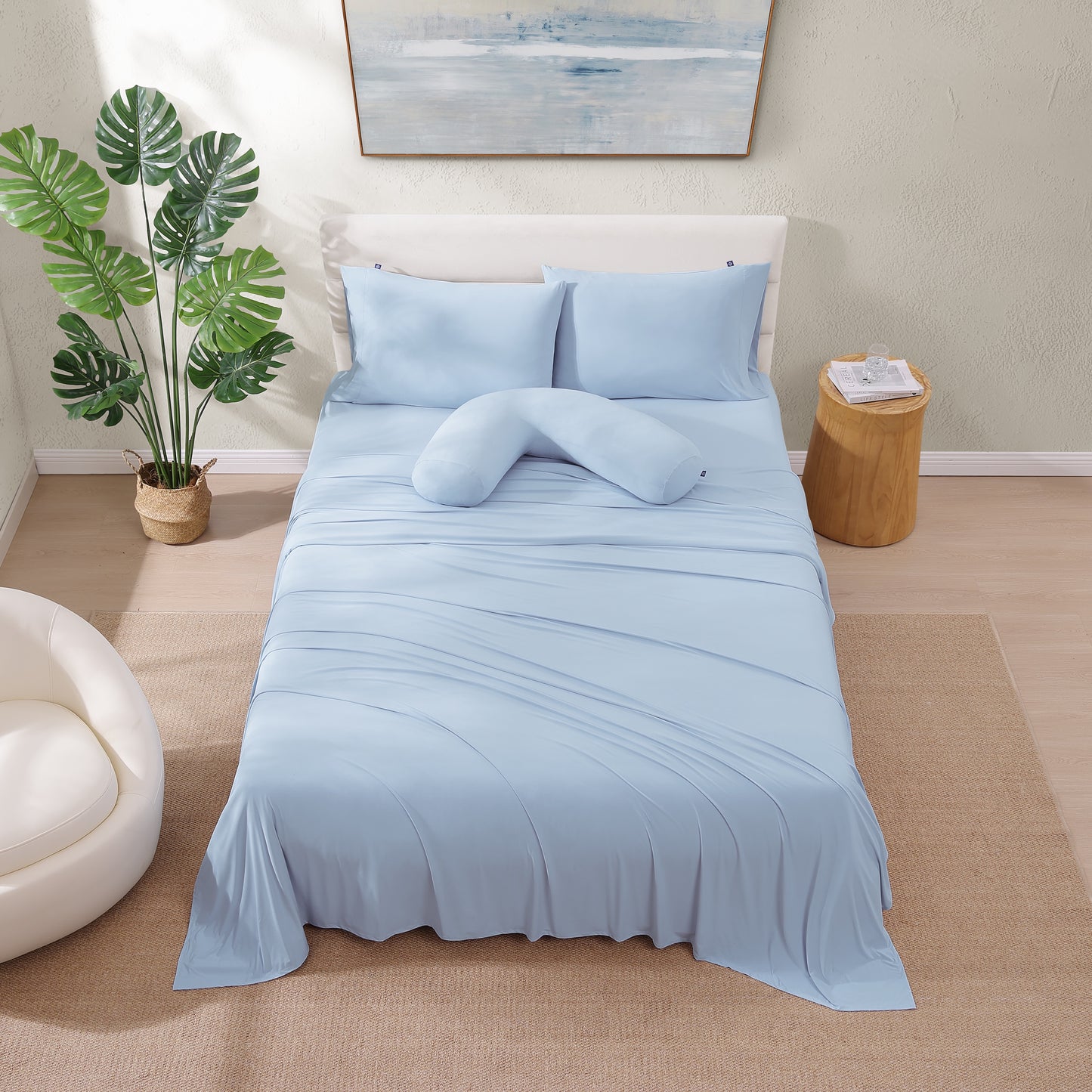 Top down view of cooling sheet set on queen bed – light blue bedding with pillowcases.