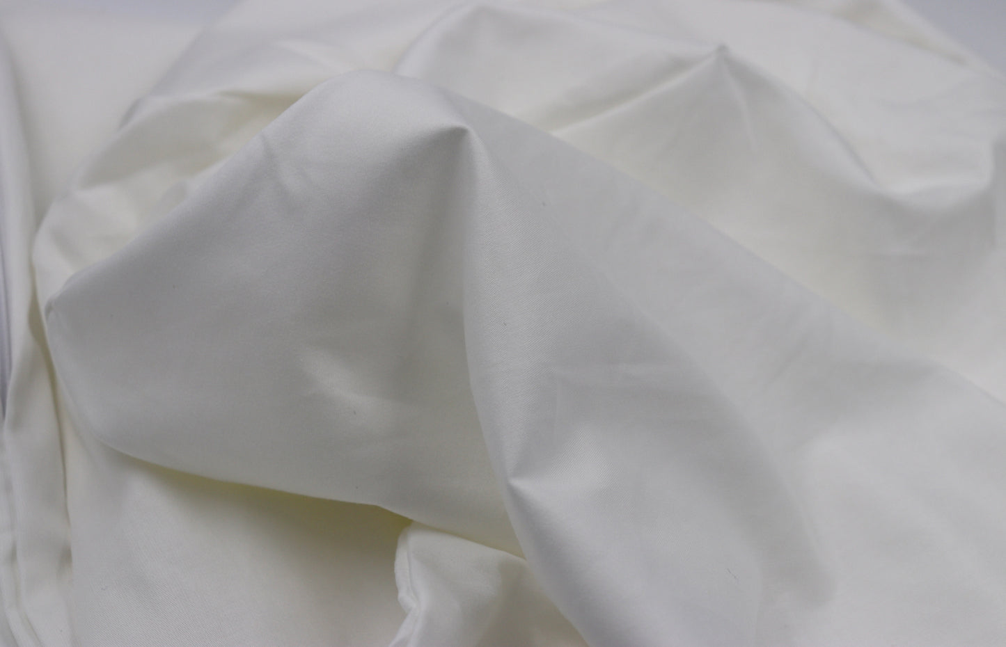 Close-up of soft white cotton percale fabric – lightweight and breathable pillowcase material